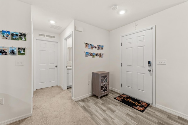 5248 NW Gamma St, Port Saint Lucie, FL 34986 - entryway featuring light wood-style flooring, baseboards, and recessed lighting
