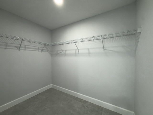 12180 SE 89th Ter, Belleview, FL 34420 - walk in closet featuring dark tile patterned flooring