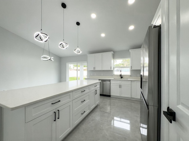 12180 SE 89th Ter, Belleview, FL 34420 - kitchen featuring stainless steel appliances, a sink, healthy amount of natural light, white cabinets, and recessed lighting