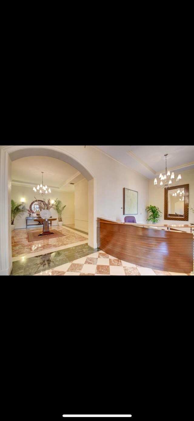 802 W Windward Way Unit 304, Lantana, FL 33462 - unfurnished dining area featuring a chandelier and arched walkways