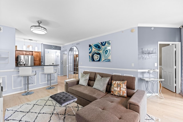 802 W Windward Way Unit 304, Lantana, FL 33462 - living area featuring light wood finished floors, crown molding, and arched walkways