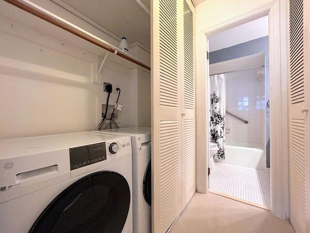 clothes washing area featuring washing machine and dryer and laundry area