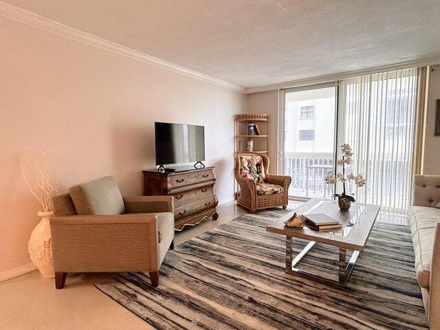 living area with crown molding