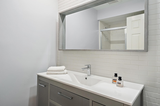2703 Fairway Dr N, Jupiter, FL 33477 - full bath featuring backsplash, vanity, and a shower stall