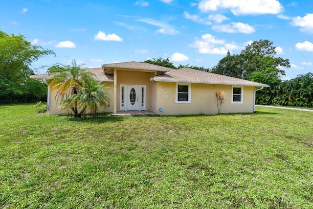 13698 63rd Ln N, The Acreage, FL 33412 - rear view of house with stucco siding and a yard