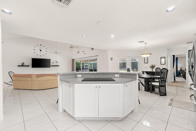 kitchen with black electric stovetop, ceiling fan, white cabinets, recessed lighting, and open floor plan