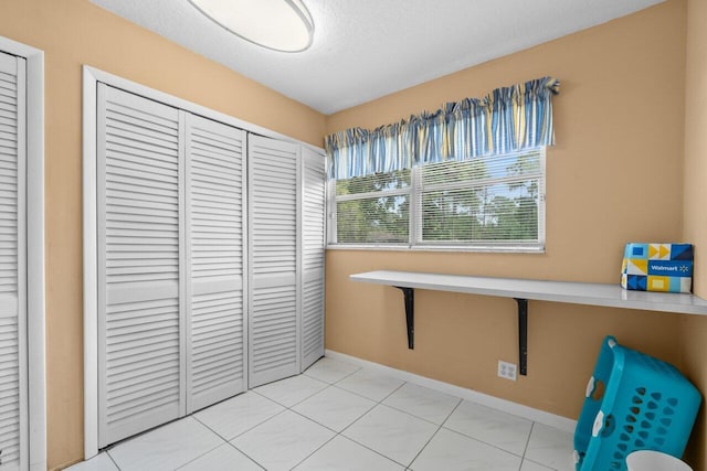 dining area featuring baseboards and a textured ceiling