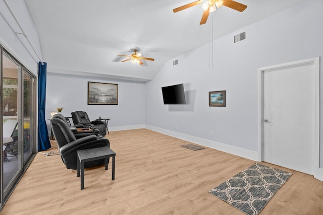 living area featuring ceiling fan, lofted ceiling, light wood-style flooring, and baseboards