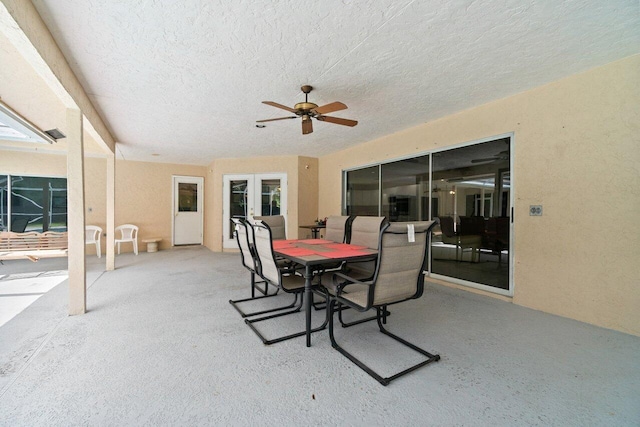 view of patio with french doors, outdoor dining space, and ceiling fan