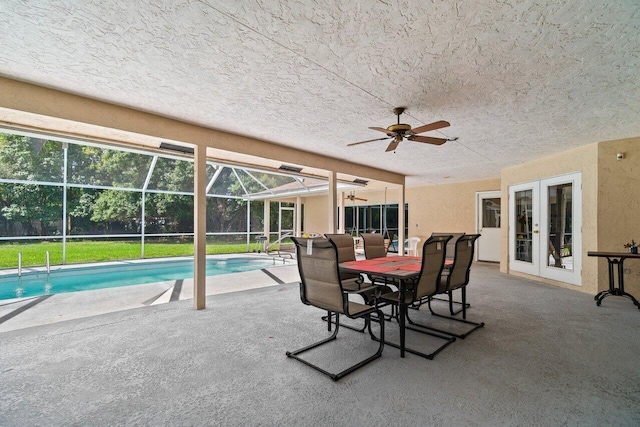 view of patio with french doors, a ceiling fan, an outdoor pool, and glass enclosure