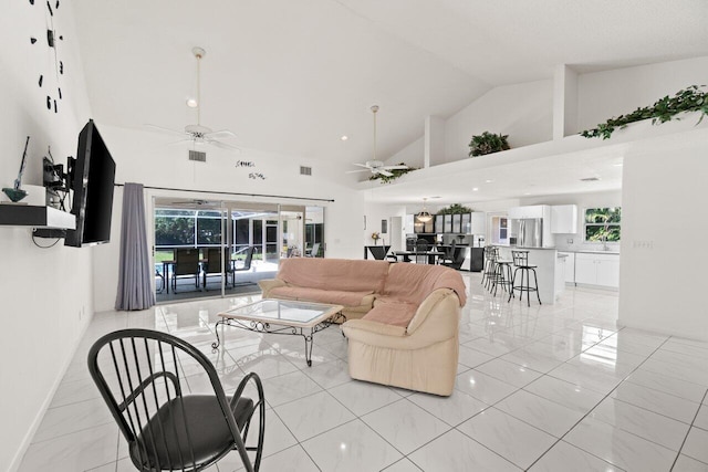 living area featuring a ceiling fan, high vaulted ceiling, and plenty of natural light