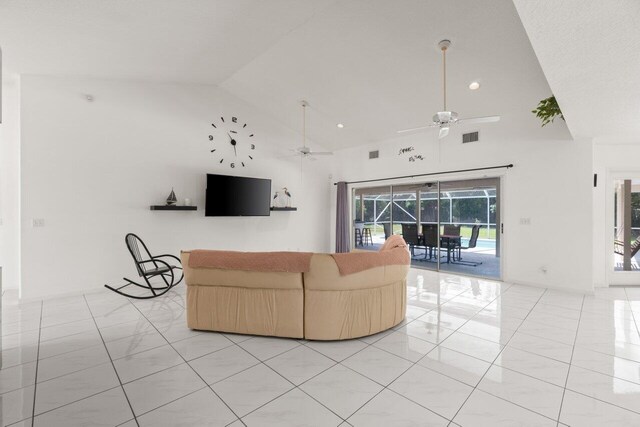 living area with ceiling fan, high vaulted ceiling, light tile patterned floors, and recessed lighting