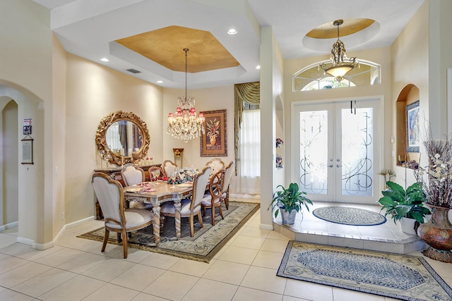 1815 Waldorf Dr, Royal Palm Beach, FL 33411 - entrance foyer featuring arched walkways, a raised ceiling, and a chandelier