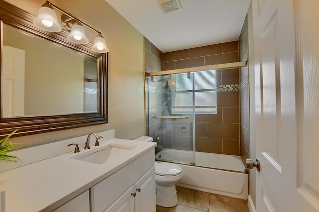 102 SW 13th Ave, Delray Beach, FL 33444 - full bathroom featuring toilet, vanity, combined bath / shower with glass door, tile patterned floors, and a textured wall