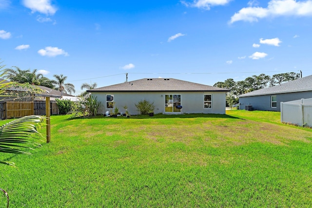 back of property with stucco siding and central AC unit