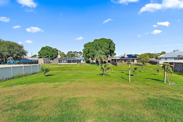 view of yard featuring fence and a residential view