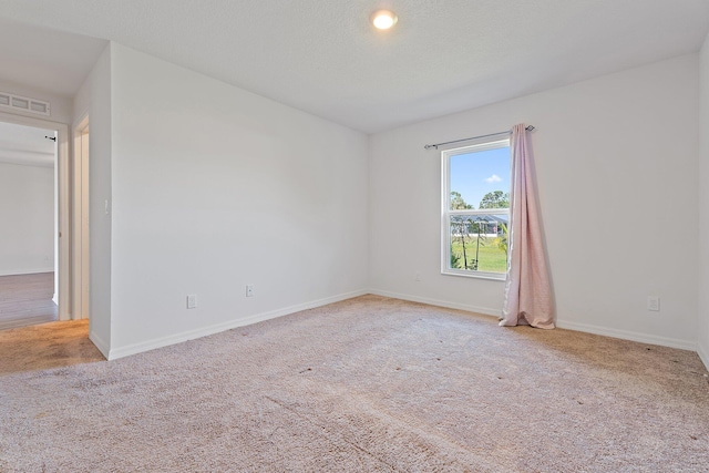 carpeted spare room with baseboards