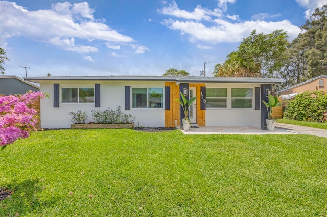115 W 31st Ct, Riviera Beach, FL 33404 - ranch-style home with a front yard and stucco siding