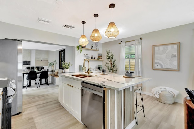 115 W 31st Ct, Riviera Beach, FL 33404 - kitchen with a sink, stainless steel dishwasher, light stone counters, and visible vents