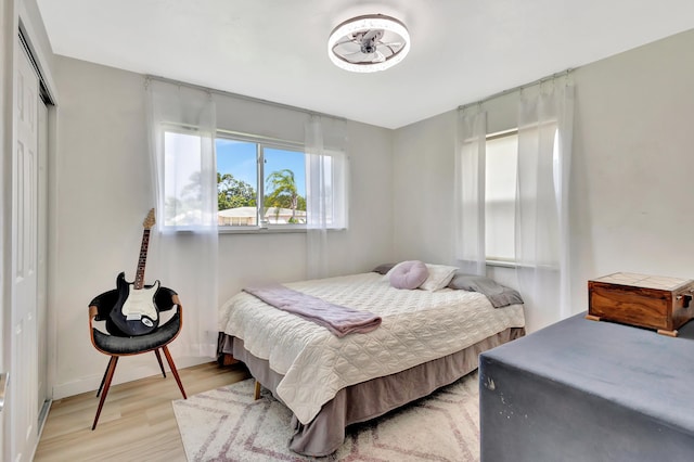 115 W 31st Ct, Riviera Beach, FL 33404 - bedroom featuring a closet and light wood-type flooring
