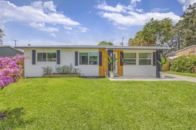 115 W 31st Ct, Riviera Beach, FL 33404 - ranch-style home with a front yard and stucco siding