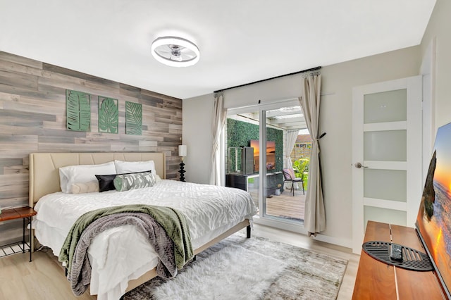 115 W 31st Ct, Riviera Beach, FL 33404 - bedroom with access to outside, an accent wall, and wood finished floors