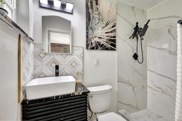 115 W 31st Ct, Riviera Beach, FL 33404 - full bath with tile walls, toilet, vanity, decorative backsplash, and a marble finish shower
