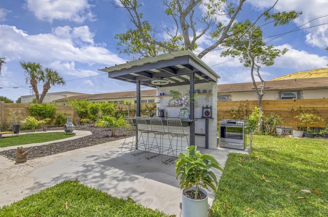 115 W 31st Ct, Riviera Beach, FL 33404 - surrounding community featuring outdoor dry bar, a patio area, a lawn, and a fenced backyard