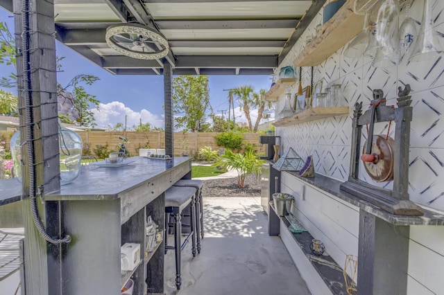 115 W 31st Ct, Riviera Beach, FL 33404 - view of patio with outdoor dry bar and a fenced backyard