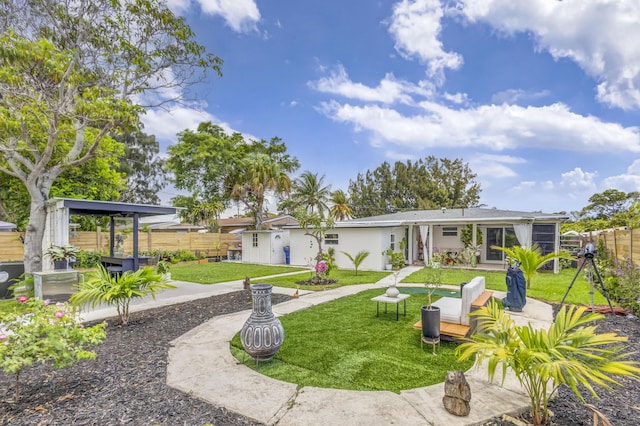 115 W 31st Ct, Riviera Beach, FL 33404 - rear view of property with a lawn and a fenced backyard