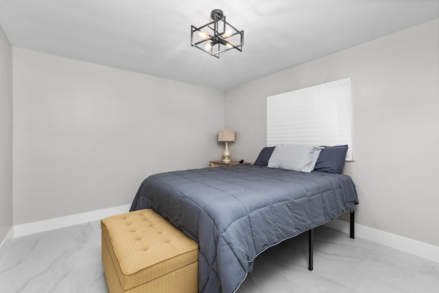 2500 NE 23rd St, Pompano Beach, FL 33062 - bedroom with an inviting chandelier, marble finish floor, and baseboards
