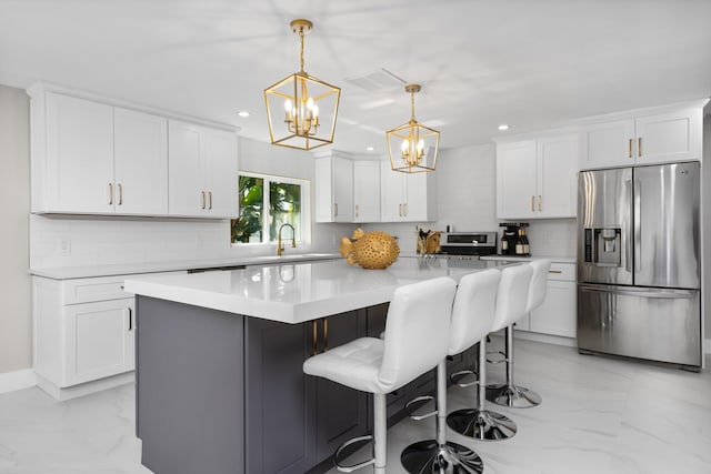 2500 NE 23rd St, Pompano Beach, FL 33062 - kitchen with recessed lighting, marble finish floor, stainless steel fridge, a chandelier, and tasteful backsplash