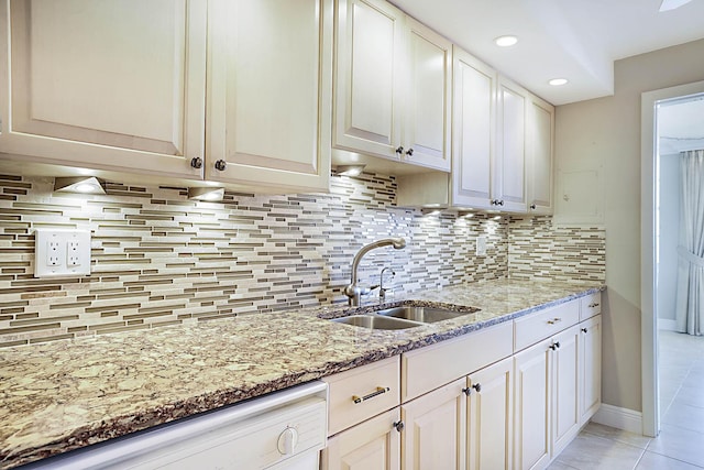 2121 N Ocean Blvd Unit 1707E, Boca Raton, FL 33431 - kitchen featuring a sink, dishwasher, light stone countertops, backsplash, and light tile patterned flooring