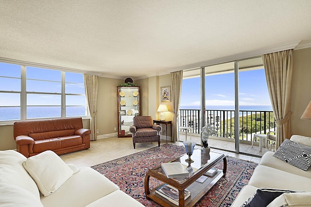 2121 N Ocean Blvd Unit 1707E, Boca Raton, FL 33431 - living area featuring a water view, crown molding, baseboards, a wall of windows, and a textured ceiling
