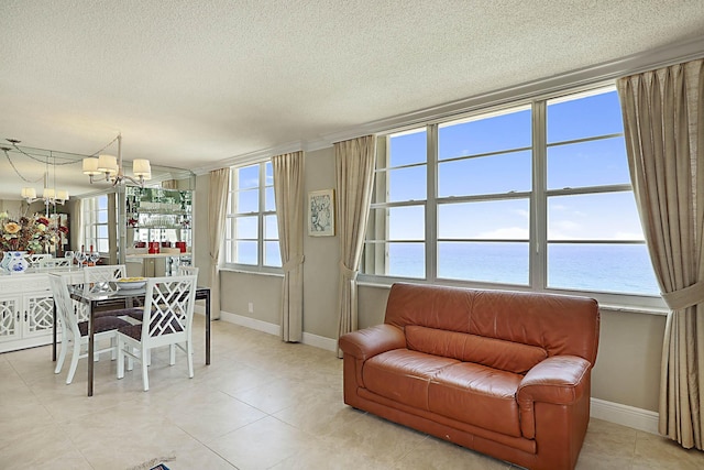 2121 N Ocean Blvd Unit 1707E, Boca Raton, FL 33431 - dining area with a chandelier, a water view, baseboards, a textured ceiling, and light tile patterned flooring