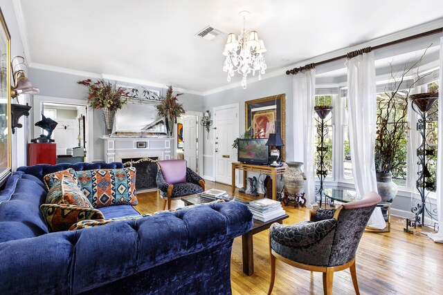 335 Monroe Dr, West Palm Beach, FL 33405 - living area featuring a chandelier, ornamental molding, wood finished floors, and a fireplace