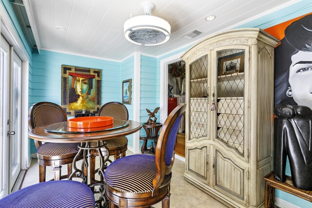 335 Monroe Dr, West Palm Beach, FL 33405 - dining space with ornamental molding and light tile patterned flooring