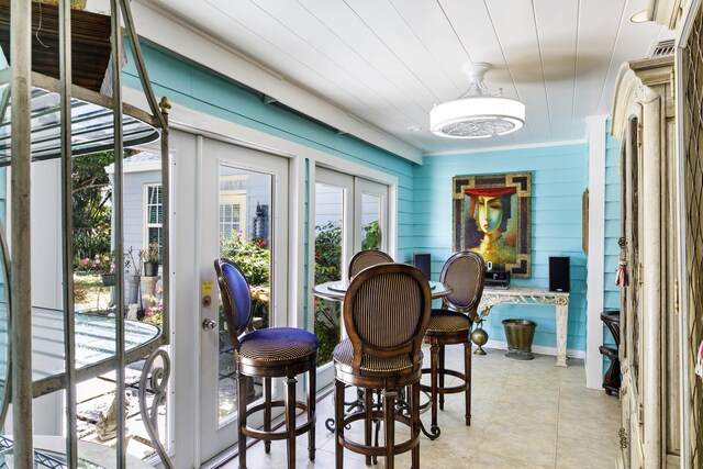 335 Monroe Dr, West Palm Beach, FL 33405 - dining space with light tile patterned floors and ornamental molding
