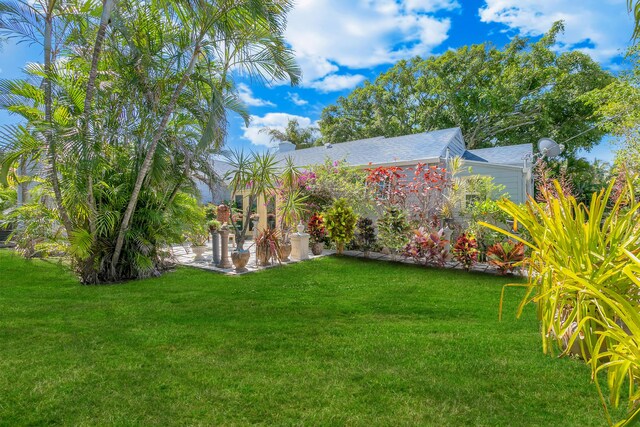 335 Monroe Dr, West Palm Beach, FL 33405 - view of grassy yard featuring a patio area