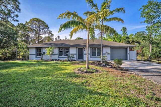 18143 42nd Rd, The Acreage, FL 33470 - ranch-style home with concrete driveway, stucco siding, a garage, and a front lawn