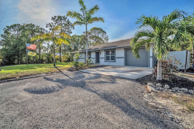 18143 42nd Rd, The Acreage, FL 33470 - single story home with driveway, a garage, stucco siding, and a front lawn