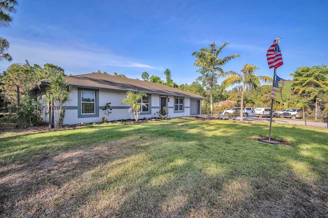 18143 42nd Rd, The Acreage, FL 33470 - ranch-style home with stucco siding and a front lawn