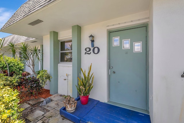 doorway to property with stucco siding