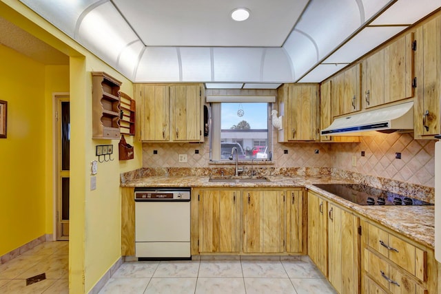 kitchen with a sink, under cabinet range hood, white dishwasher, black electric cooktop, and decorative backsplash