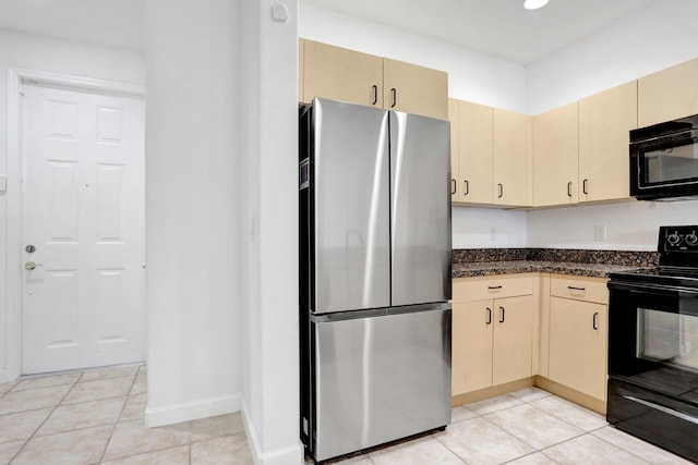 3599 NW 14th Ct, Lauderhill, FL 33311 - kitchen featuring black appliances, light tile patterned flooring, cream cabinetry, and baseboards
