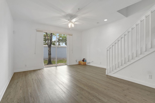 3599 NW 14th Ct, Lauderhill, FL 33311 - unfurnished living room featuring ceiling fan, wood finished floors, stairway, baseboards, and recessed lighting