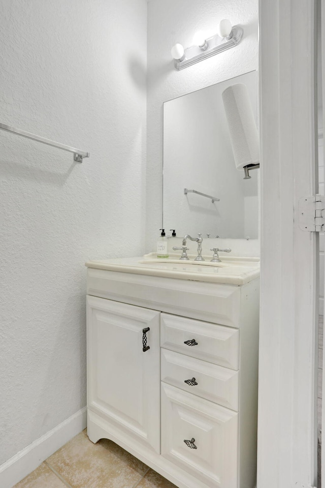 3599 NW 14th Ct, Lauderhill, FL 33311 - bathroom featuring vanity, tile patterned floors, baseboards, and a textured wall