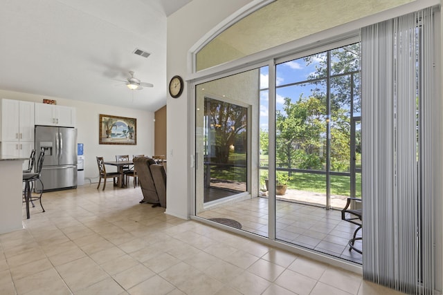 1235 SW Briarwood Dr, Port Saint Lucie, FL 34986 - doorway to outside with ceiling fan, light tile patterned flooring, and healthy amount of natural light