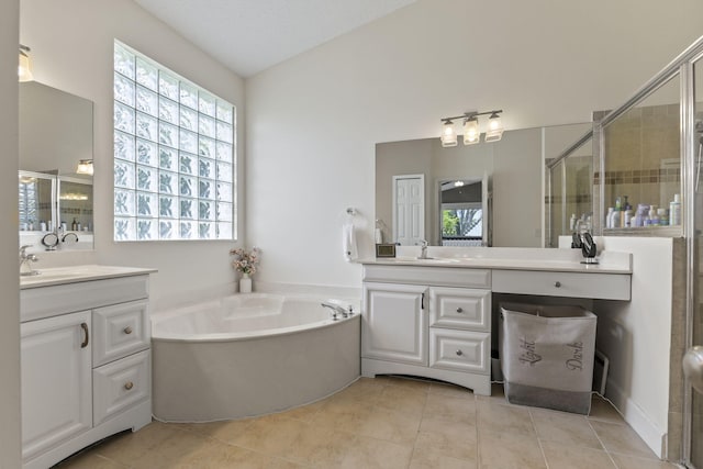 1235 SW Briarwood Dr, Port Saint Lucie, FL 34986 - full bathroom featuring a shower stall, a garden tub, vanity, and tile patterned floors