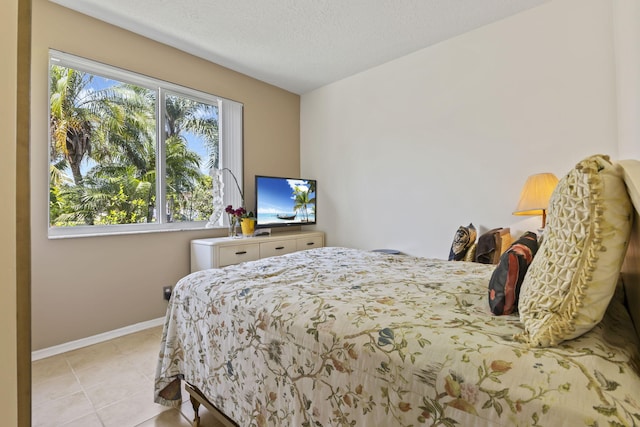1235 SW Briarwood Dr, Port Saint Lucie, FL 34986 - bedroom with baseboards, tile patterned flooring, and a textured ceiling